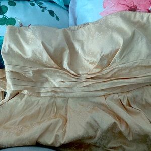 Light golden strapless dress with white floral pattern